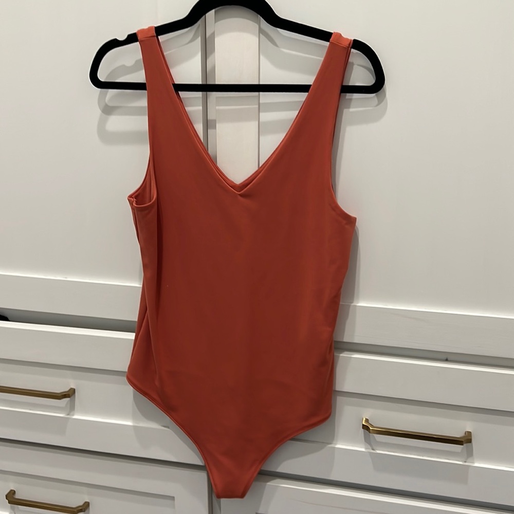 Abercrombie and Fitch orange body suit. New without tags. Size Large.